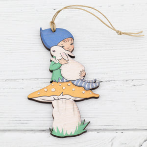 Boy and rabbit on a mushroom wooden decoration